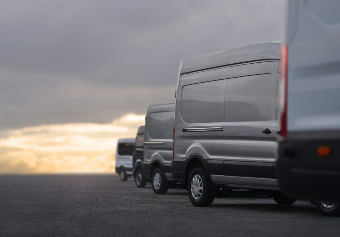 Commercial,Vans,In,Row,On,Dealership,Parking