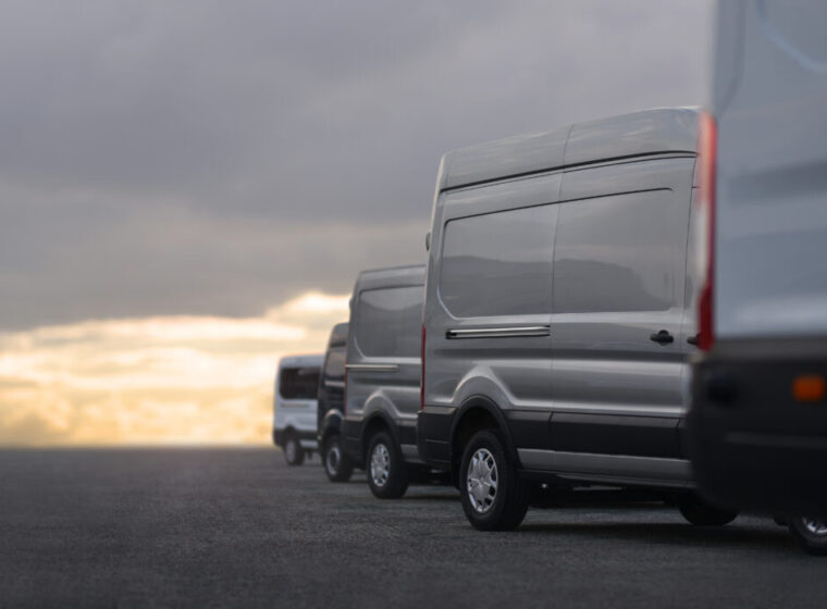 Commercial,Vans,In,Row,On,Dealership,Parking
